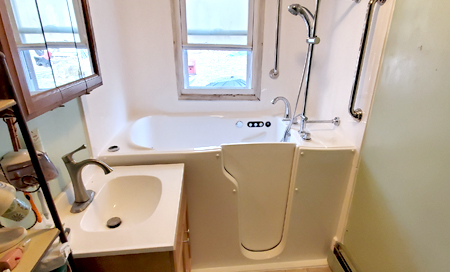 Photo of a walk-in tub with a shower extension.