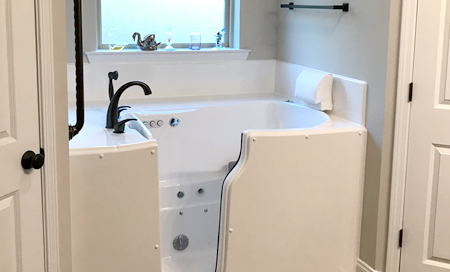 Photo of a white walk-in tub in a clean contemporary bathroom.